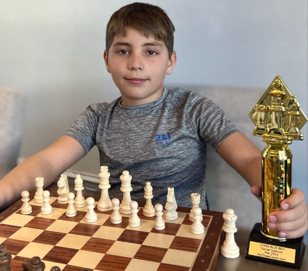 A young chess student focused on the board